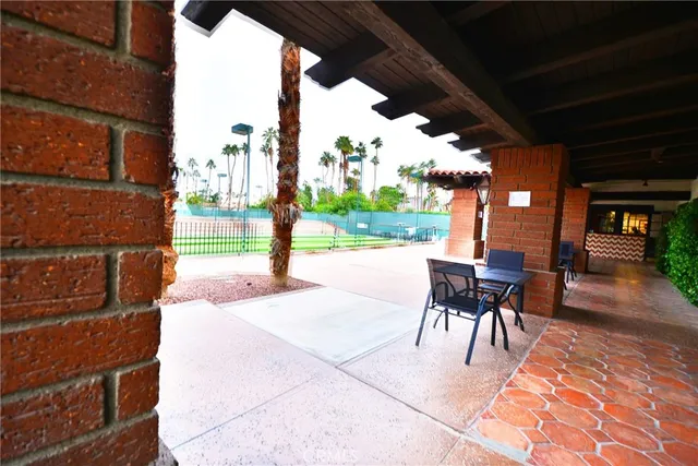 a front view of a building with a garden and plants