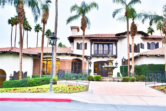 a view of a swimming pool with a patio and a garden