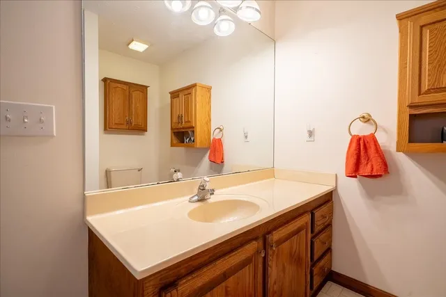 a bathroom with a sink vanity and a mirror