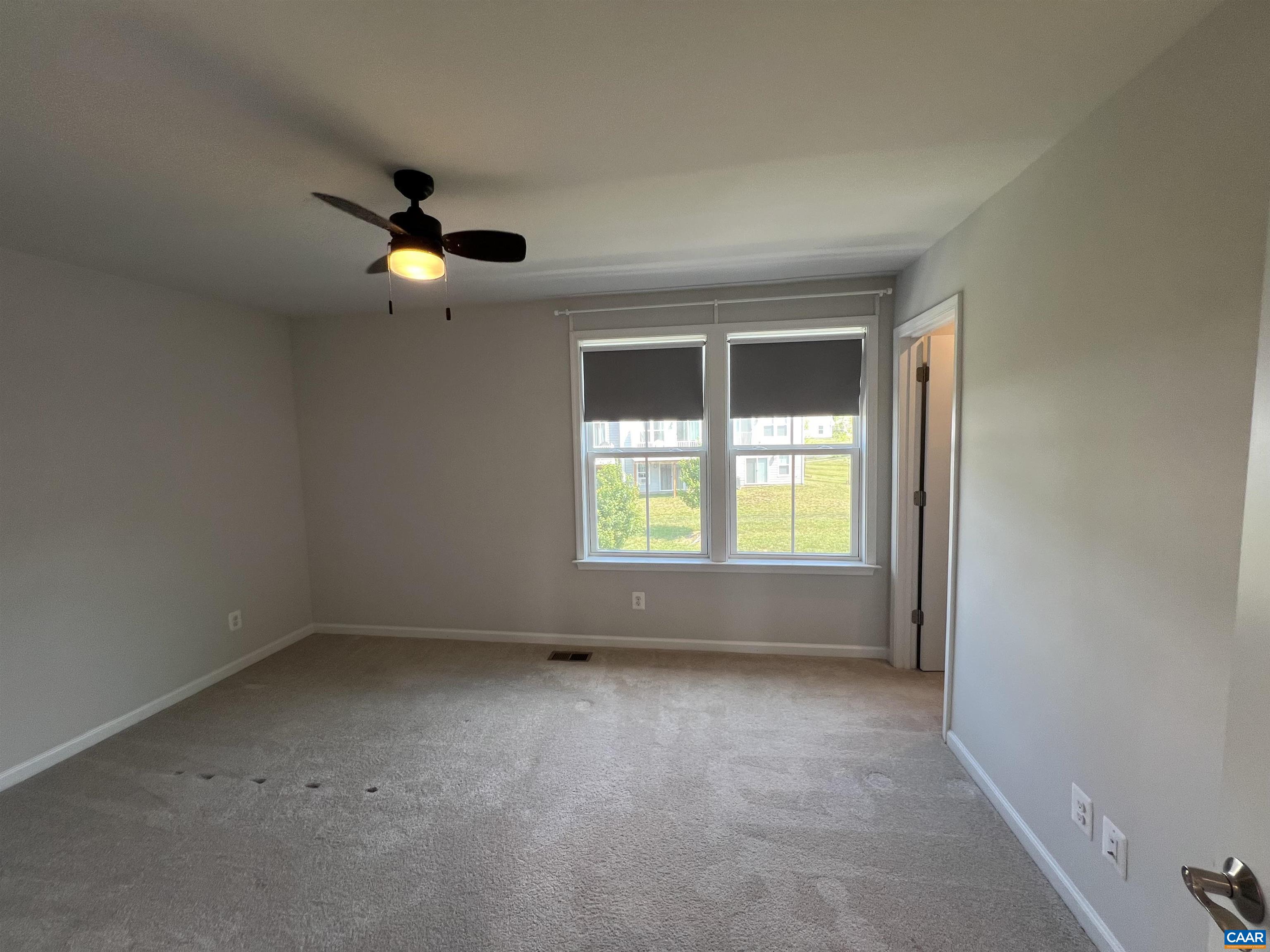 4440 Alston Street Crozet, VA 22932 - Photo 11 of 25 an empty room with windows and chandelier fan