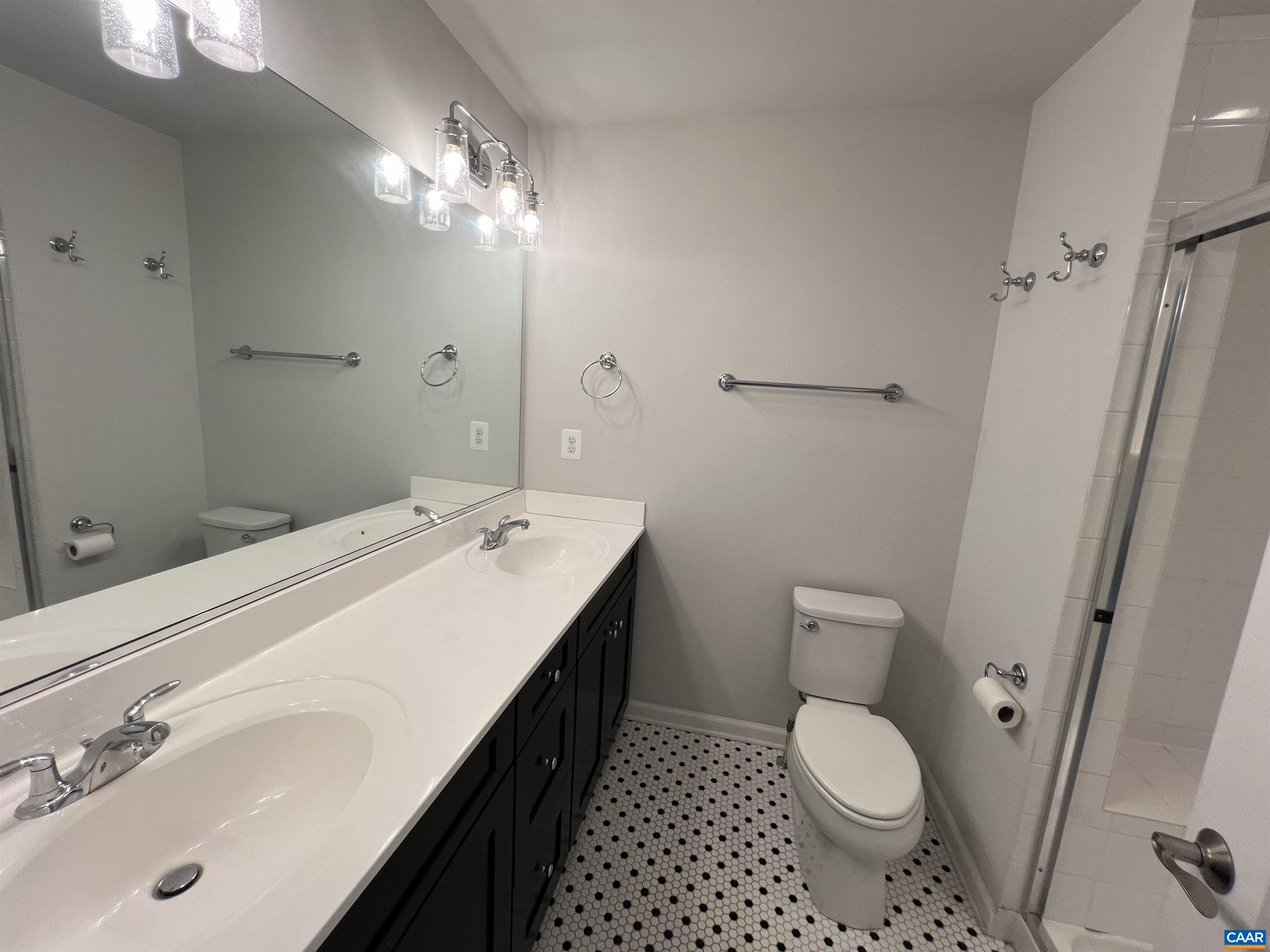 4440 Alston Street Crozet, VA 22932 - Photo 12 of 25 a bathroom with a sink a toilet a mirror and shower