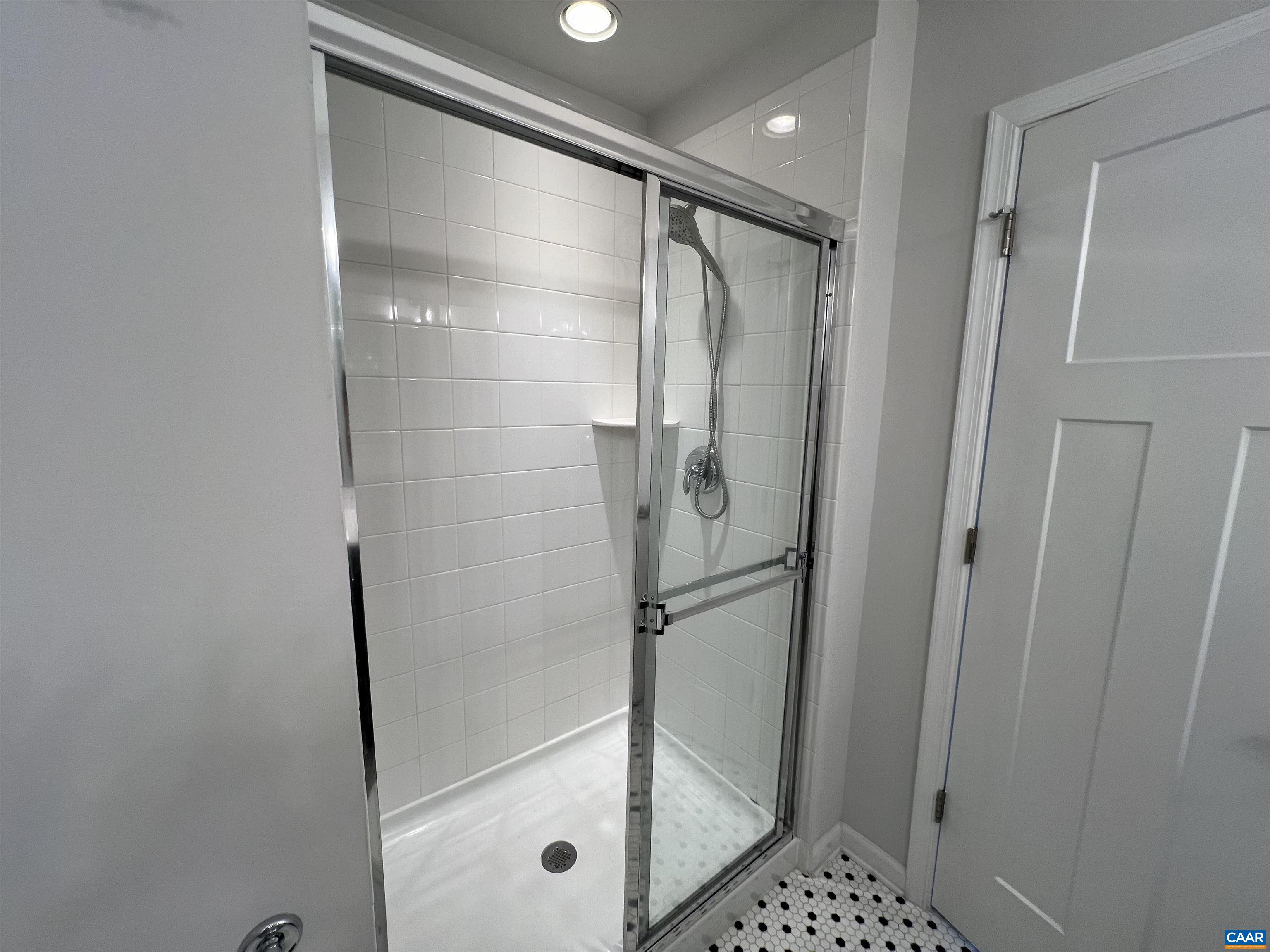 4440 Alston Street Crozet, VA 22932 - Photo 13 of 25 a bathroom with a glass shower door and a sink