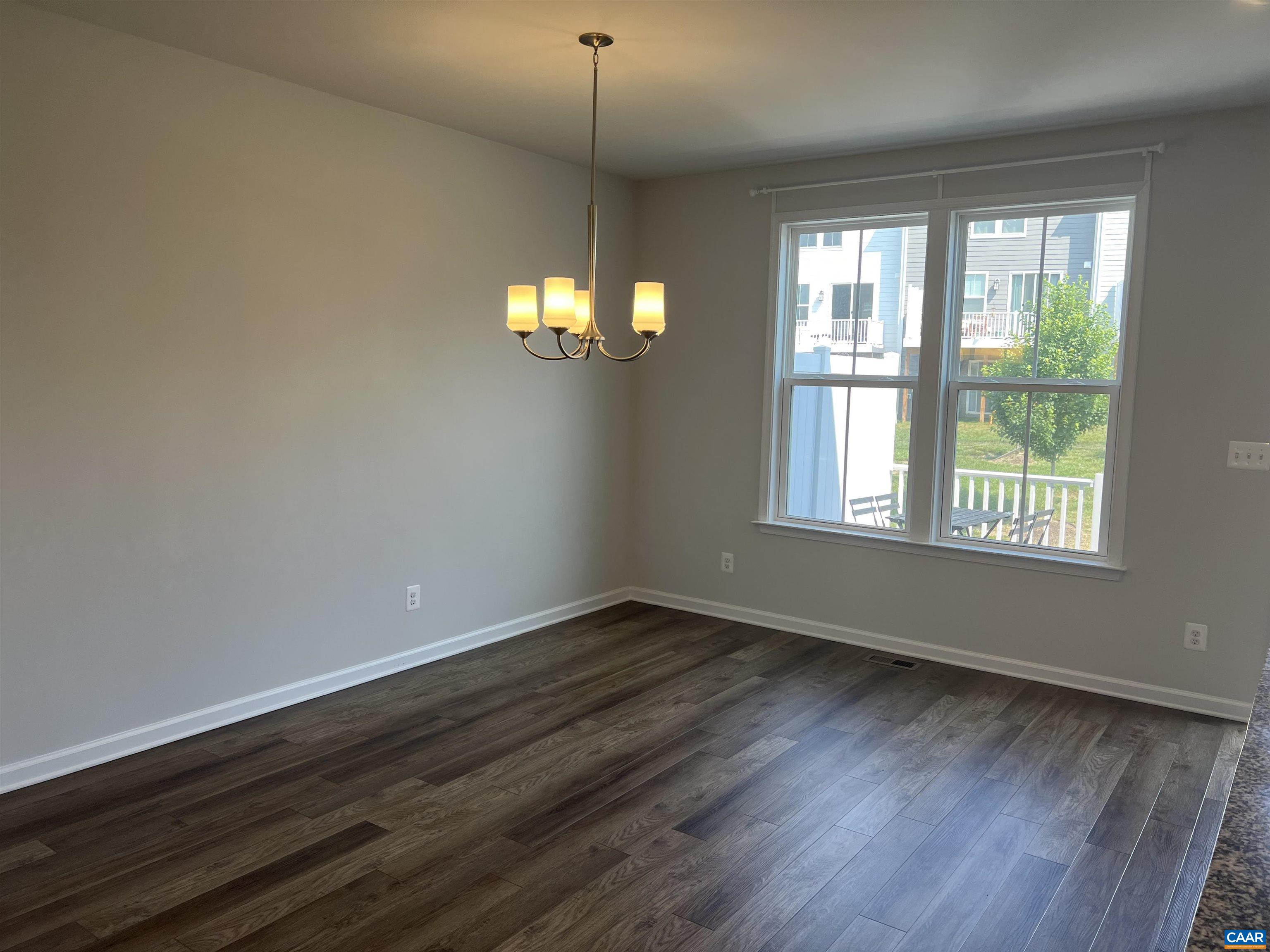 4440 Alston Street Crozet, VA 22932 - Photo 4 of 25 a view of an empty room with wooden floor and a window