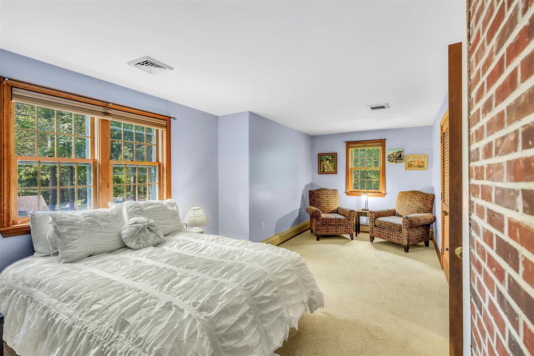 159 Old Chatham Road Brewster, MA 02631 - Photo 15 of 32 a spacious bedroom with a bed and a couch