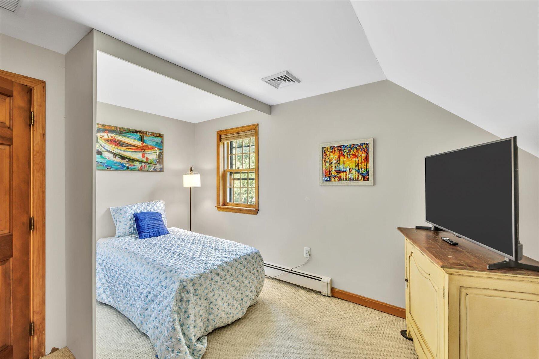 159 Old Chatham Road Brewster, MA 02631 - Photo 18 of 32 a bedroom with a bed and a flat screen tv