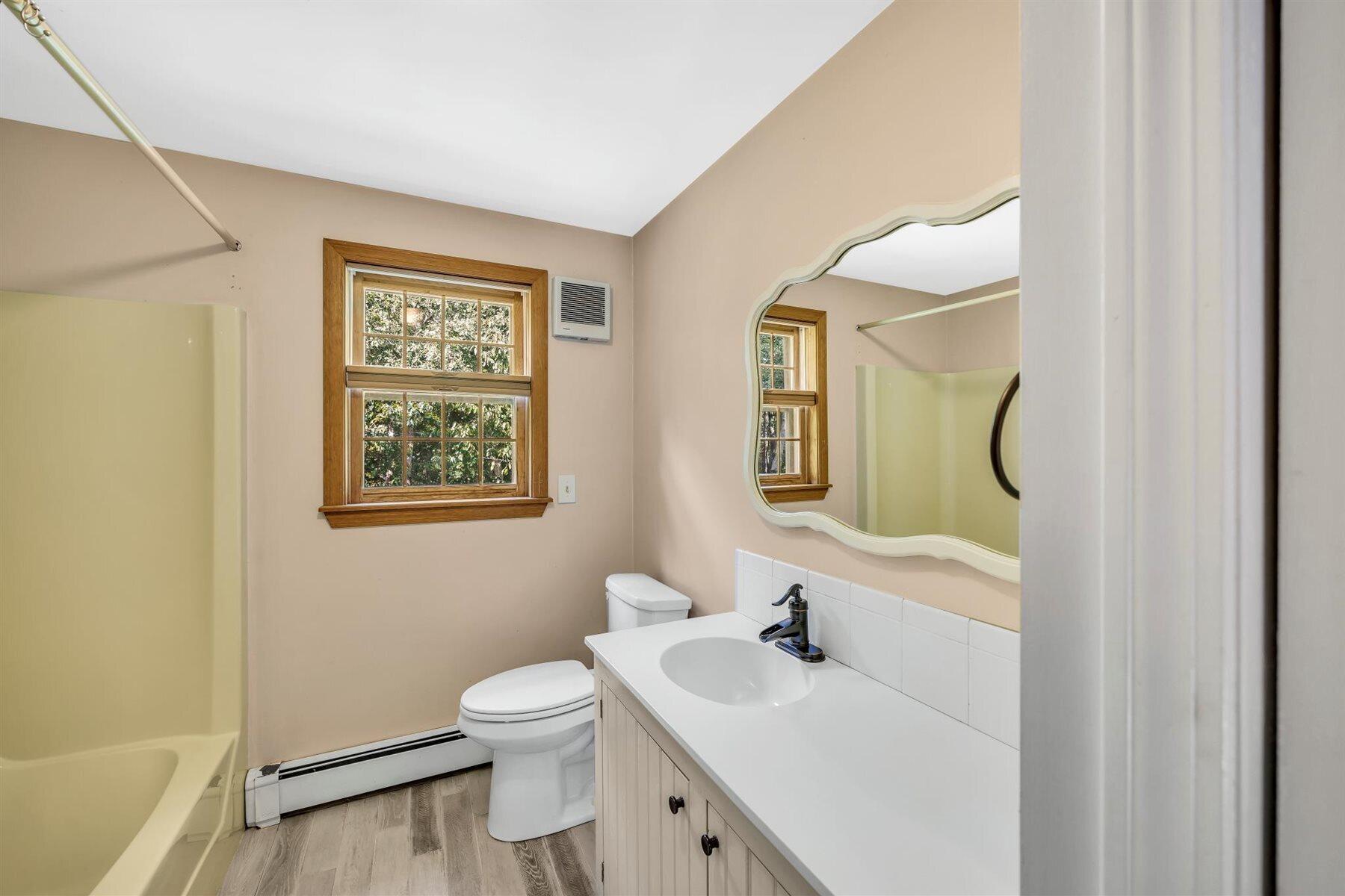 159 Old Chatham Road Brewster, MA 02631 - Photo 19 of 32 a bathroom with a toilet sink vanity and mirror
