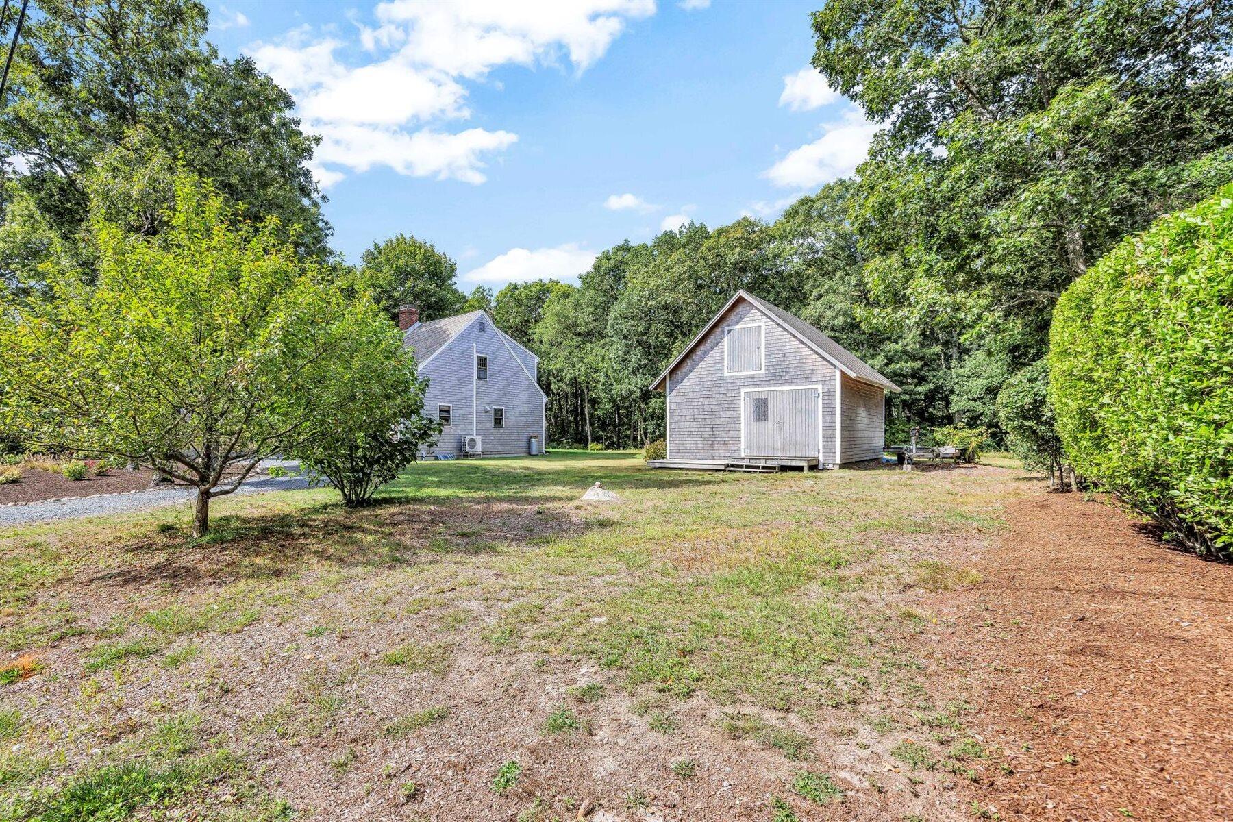159 Old Chatham Road Brewster, MA 02631 - Photo 22 of 32 a house with trees in the background