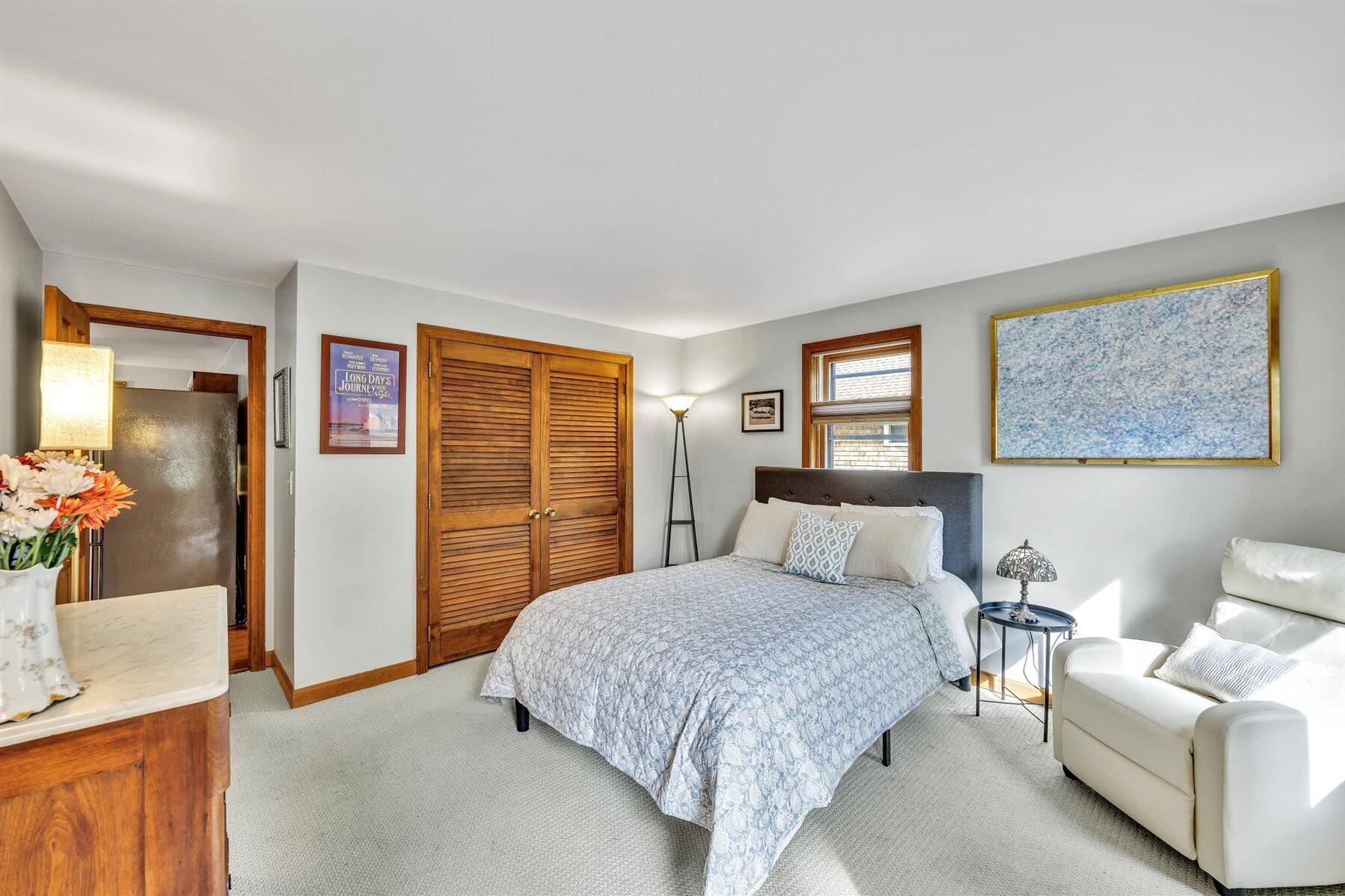 159 Old Chatham Road Brewster, MA 02631 - Photo 4 of 32 a bedroom with a bed and a couch