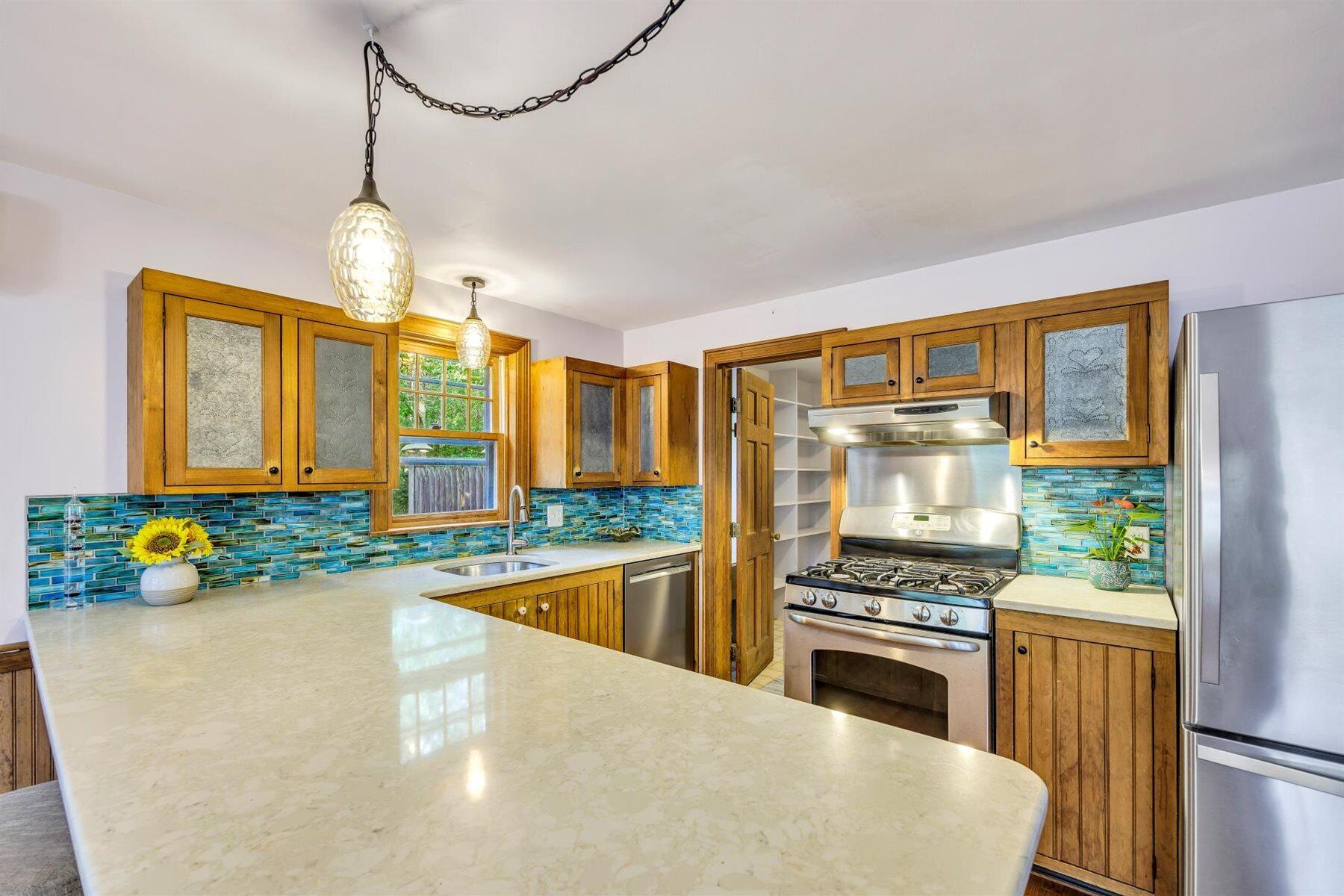 159 Old Chatham Road Brewster, MA 02631 - Photo 10 of 32 a kitchen with stainless steel appliances granite countertop a stove a sink and a refrigerator