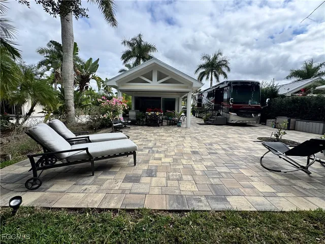 a view of a patio with table and chairs under an umbrella