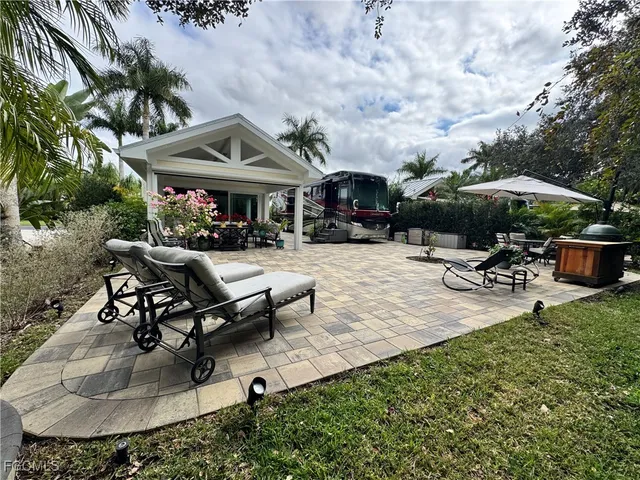 a living room with furniture flowerpot and a chandelier