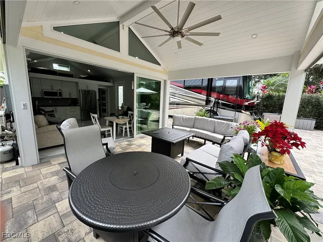 a living room with patio furniture and a floor to ceiling window