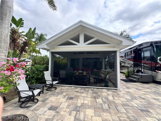 a view of house with outdoor space and potted plants