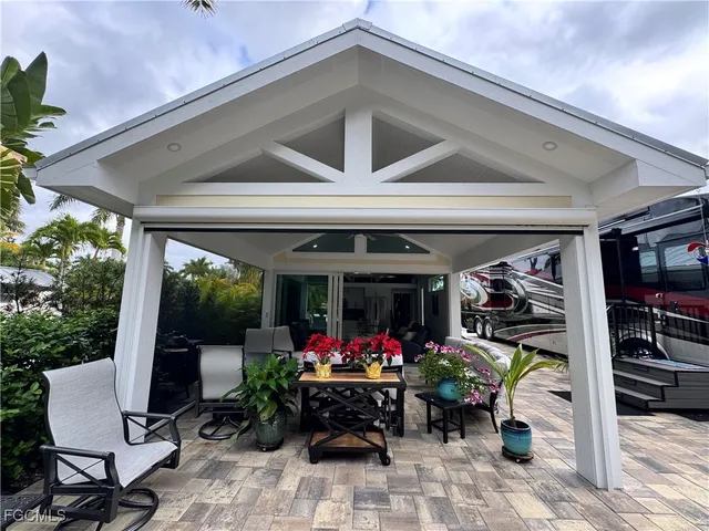 a living room with patio furniture and a floor to ceiling window