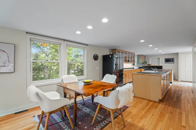 a view of a dining room with furniture window and wooden floor