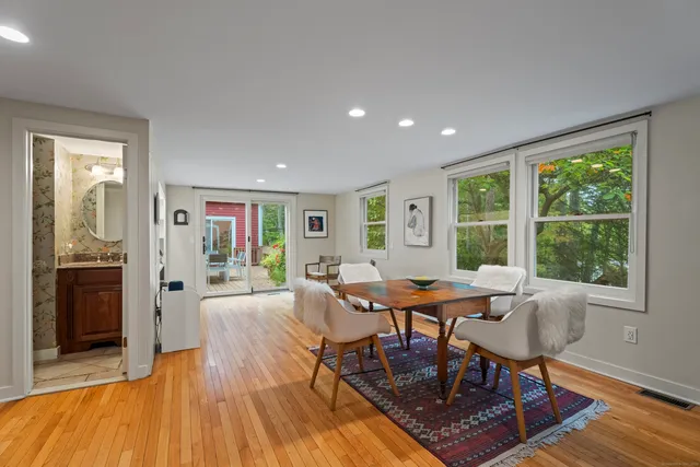 a dining room with furniture and wooden floor