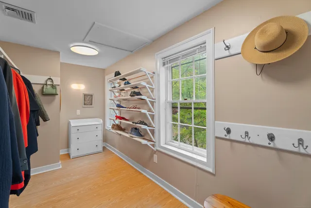 a view of walk in closet with clothes and shoes