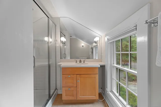a view of a sink and dishwasher with wooden floor