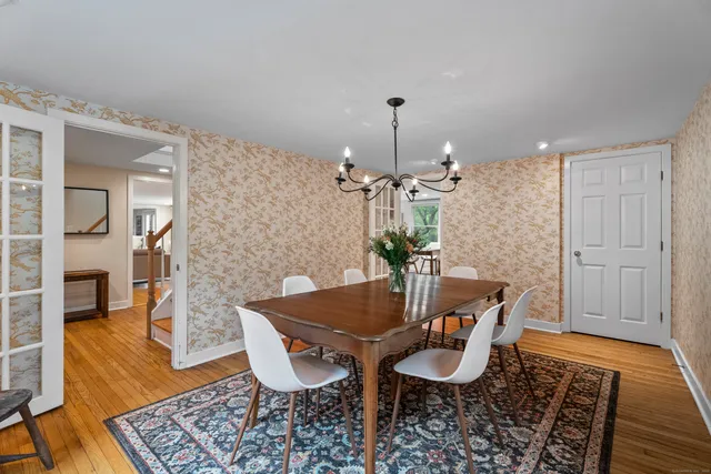 a view of a dining room with furniture and wooden floor