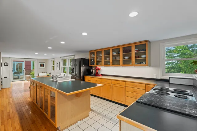 a kitchen with stainless steel appliances granite countertop a sink and a stove
