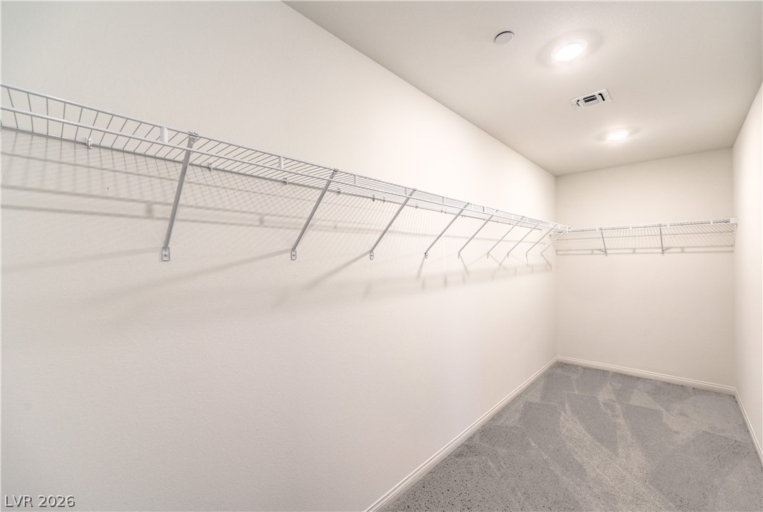 3782 Alla Rocca Avenue Henderson, NV 89044 - Photo 27 of 55 This spacious walk-in closet offers ample storage and modern recessed lighting.