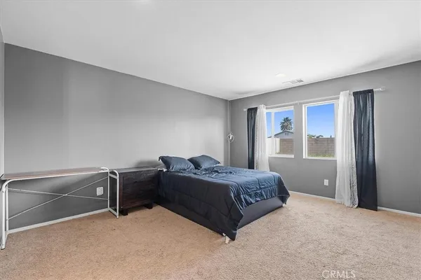 a bedroom with a bed and with furniture