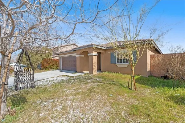 a backyard of a house with a table and chair