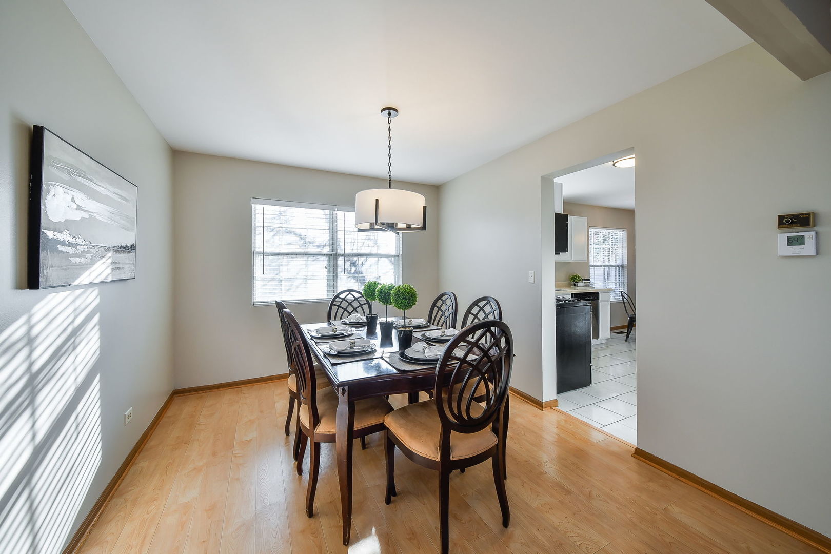 119 Canton Lane Streamwood, IL 60107 - Photo 8 of 28 a view of a dining room with furniture window and wooden floor