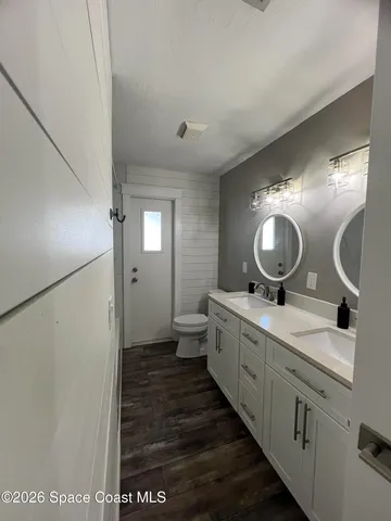 a bathroom with a double vanity sink and a mirror