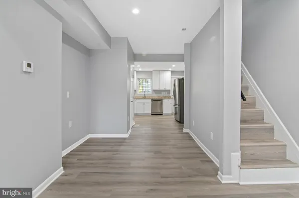 a view of a hallway view with wooden floor and staircase