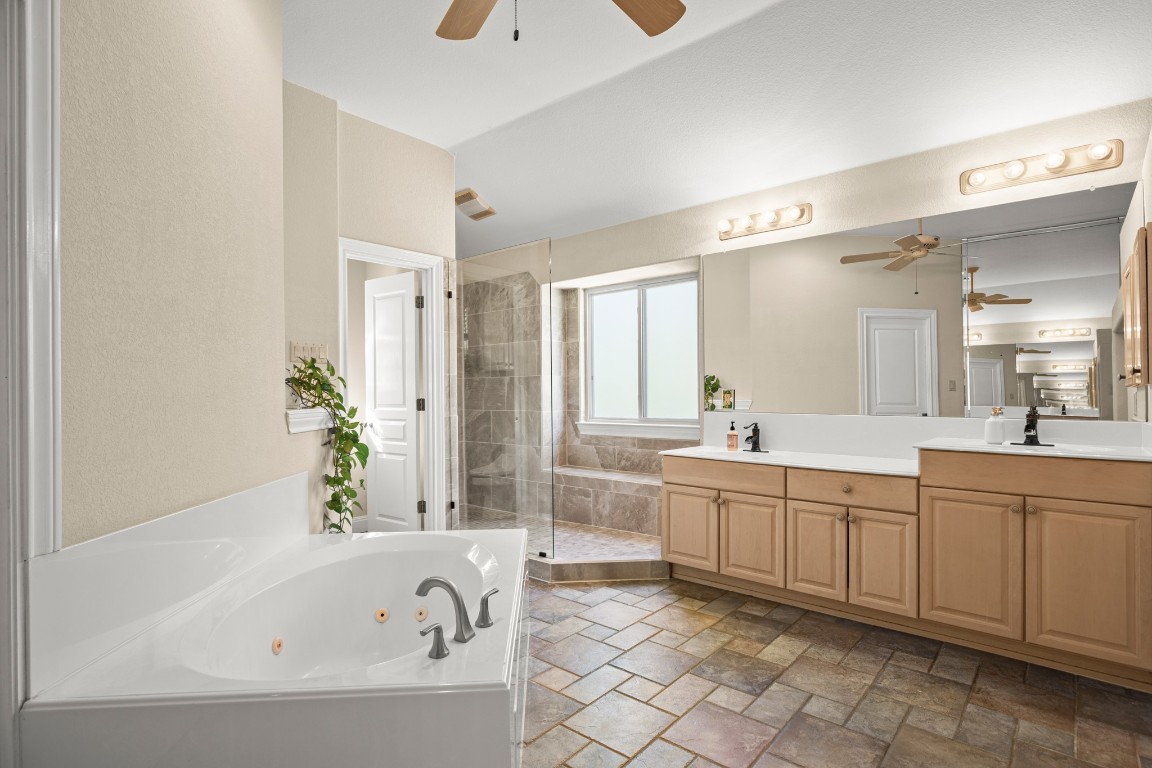 149 Spanish Oak Trail Elgin, TX 78621 - Photo 18 of 25 a large spacious bathroom with a bathtub sink and mirror