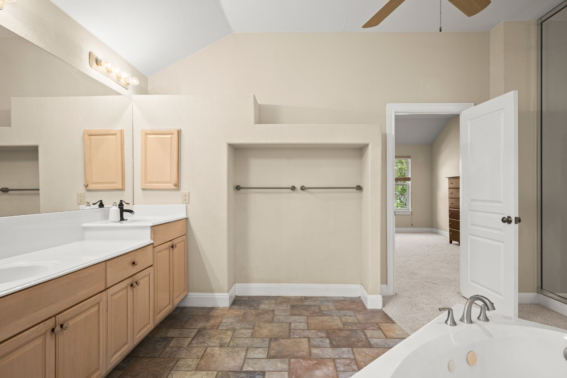 149 Spanish Oak Trail Elgin, TX 78621 - Photo 19 of 25 a spacious bathroom with a tub sink and mirror