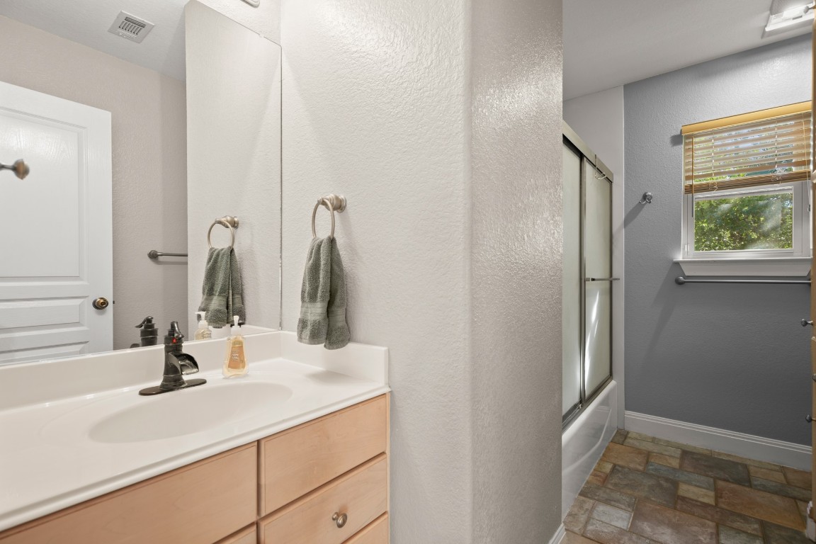 149 Spanish Oak Trail Elgin, TX 78621 - Photo 21 of 25 a bathroom with a sink and a mirror
