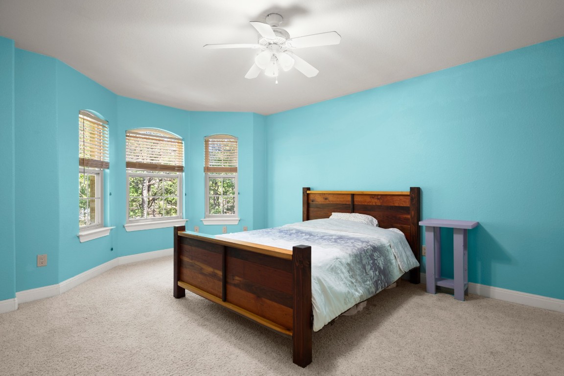 149 Spanish Oak Trail Elgin, TX 78621 - Photo 23 of 25 a bed sitting in a spacious bedroom next to a window