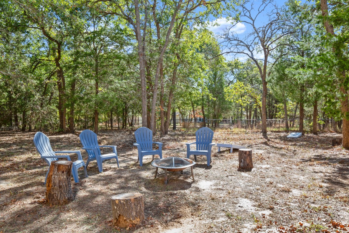 149 Spanish Oak Trail Elgin, TX 78621 - Photo 5 of 25 a view of a tables and chairs on the deck