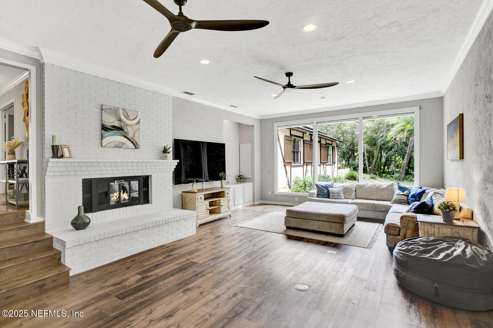 3565 Red Cloud Trail St. Augustine, FL 32086 - Photo 16 of 56 a living room with furniture a flat screen tv and a fireplace