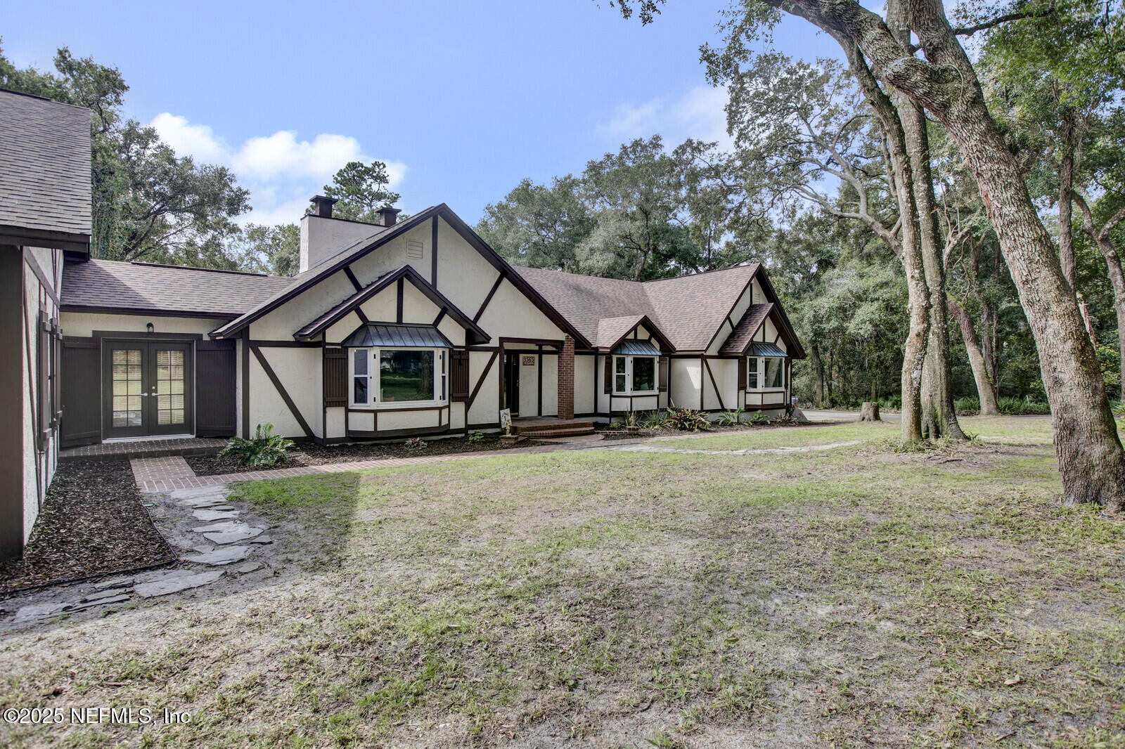 3565 Red Cloud Trail St. Augustine, FL 32086 - Photo 3 of 56 a view of a house with a yard and large tree