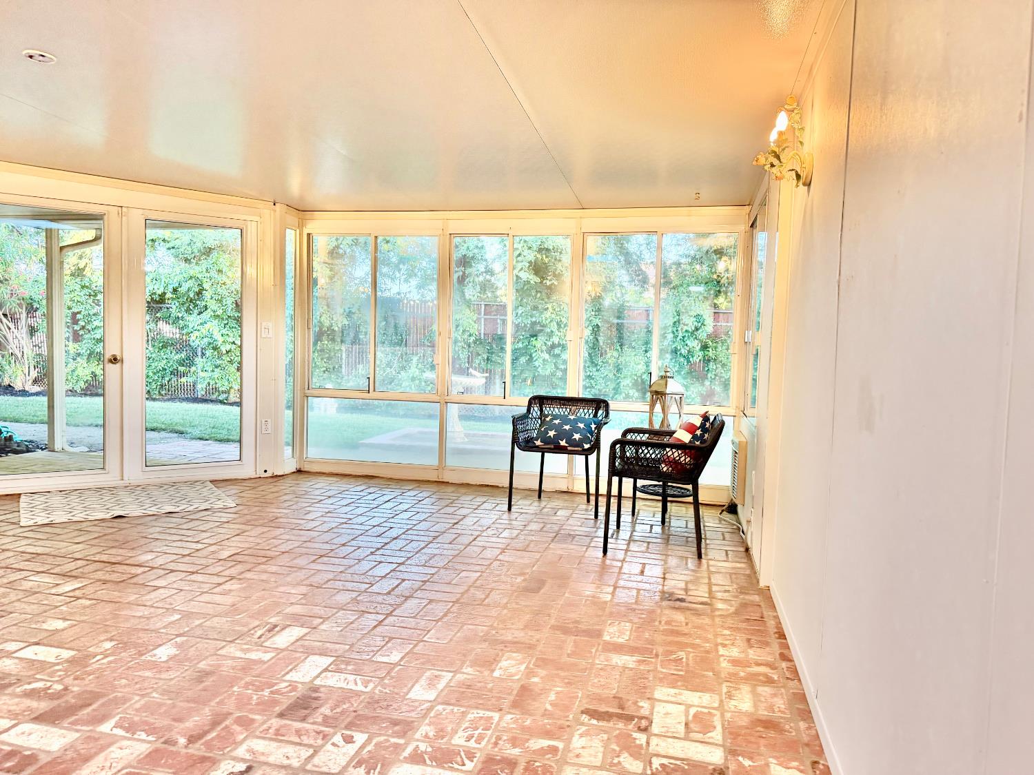 5706 Jeff Way Carmichael, CA 95608 - Photo 11 of 48 Sunroom with brick floor and windows all along the back for park like backyard views with tall redwoods. Sunroom has its own air conditioning unit for keeping cool on those hot summer days.