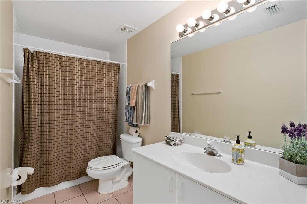 519 Roma Court, Unit 306 Naples, FL 34110 - Photo 13 of 15 a bathroom with a sink toilet and shower