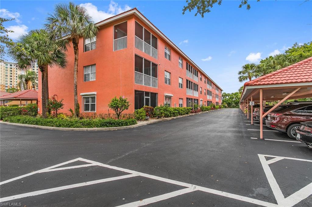 519 Roma Court, Unit 306 Naples, FL 34110 - Photo 15 of 15 front view of a house with a street