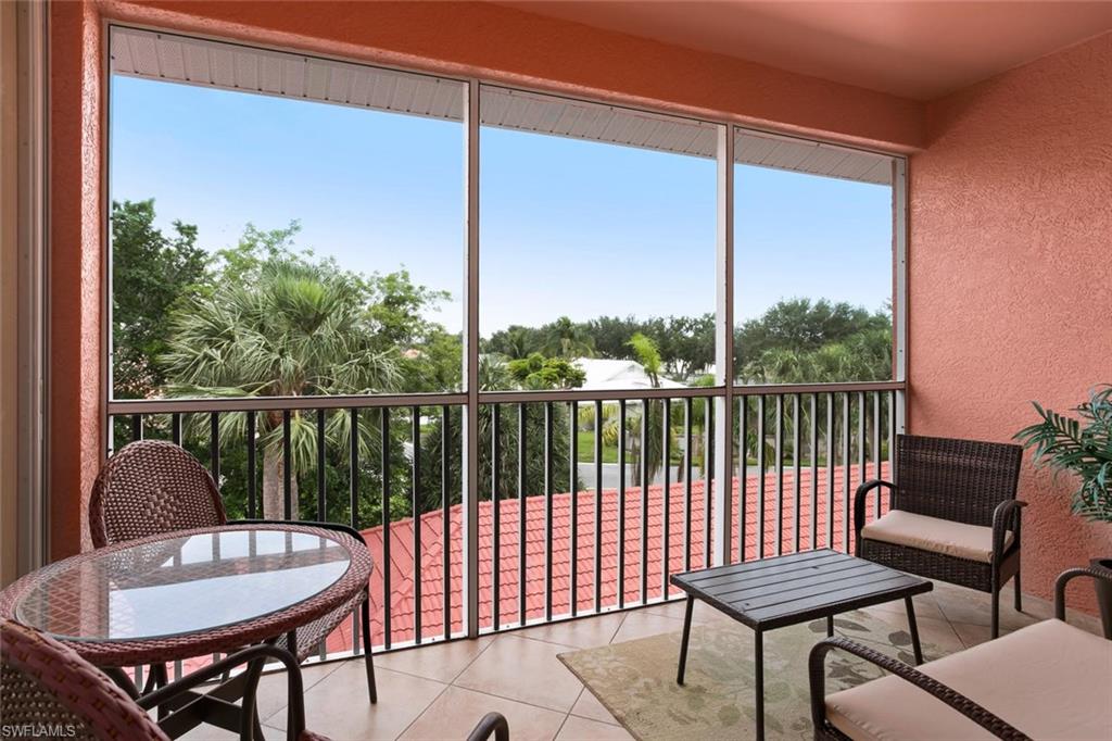519 Roma Court, Unit 306 Naples, FL 34110 - Photo 2 of 15 a balcony with chairs and a table