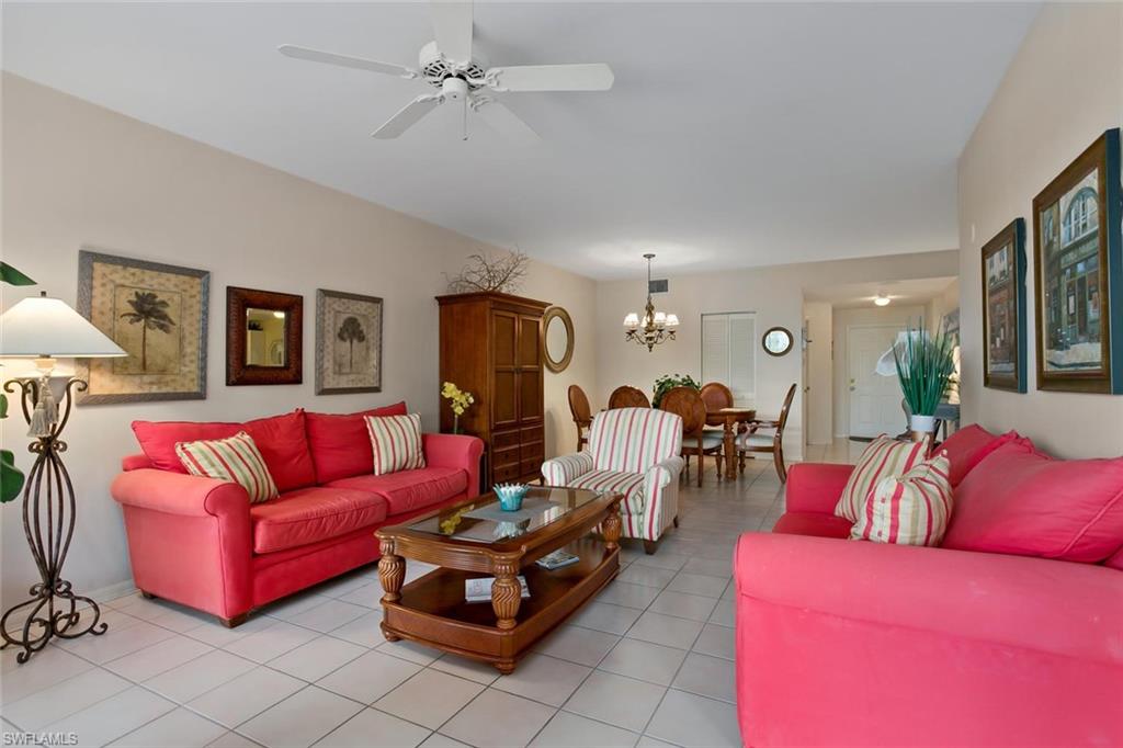 519 Roma Court, Unit 306 Naples, FL 34110 - Photo 7 of 15 a living room with furniture and a chandelier