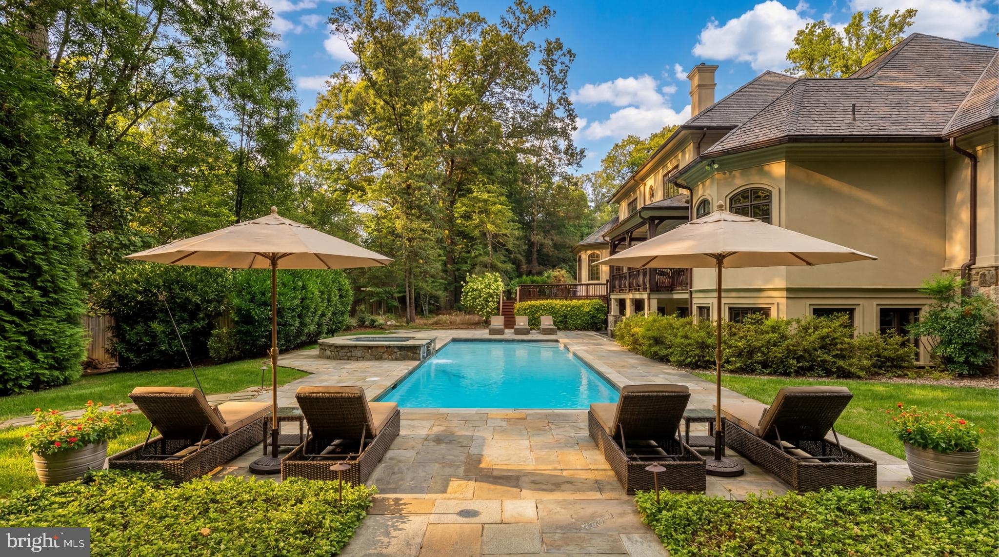 9250 Persimmon Tree Road Potomac, MD 20854 - Photo 45 of 47 a view of a house with backyard sitting area and swimming pool