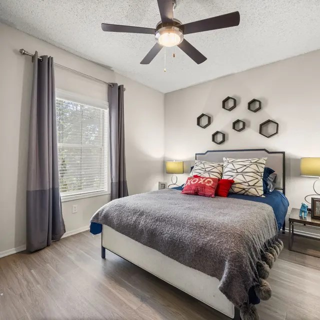 13005 Heinemann Drive, Unit 2208 Austin, TX 78727 - Photo 3 of 17 a bedroom with a bed and a large window