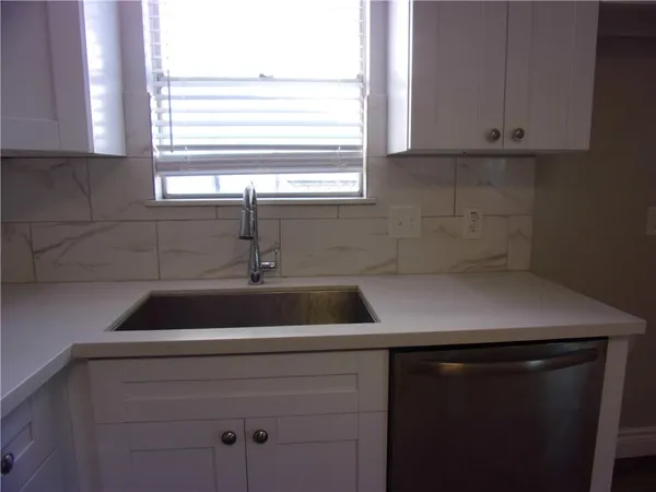a kitchen with a sink and cabinets