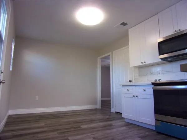 a kitchen with stainless steel appliances a stove microwave and sink