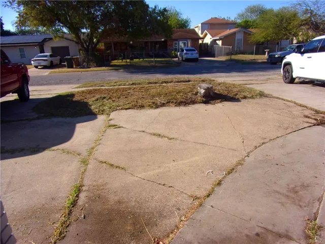 a view of a large house with a yard and large tree