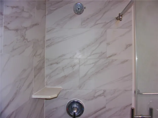 a bathroom with a glass shower door