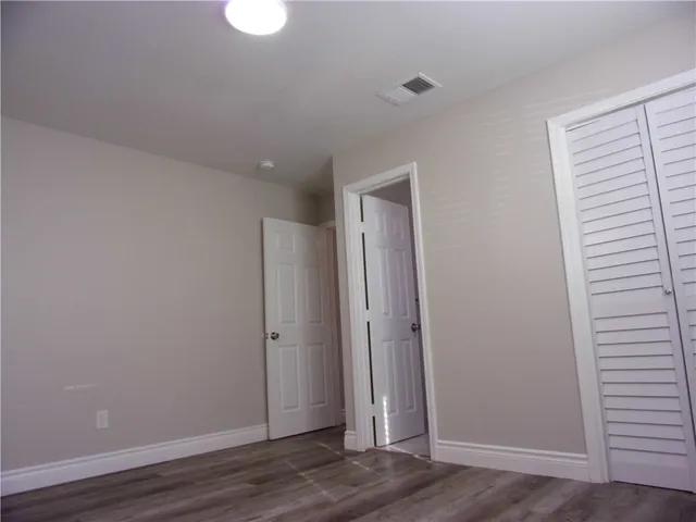 a view of a room with wooden floor and windows