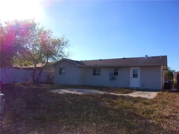 a view of a large house with a yard and large tree